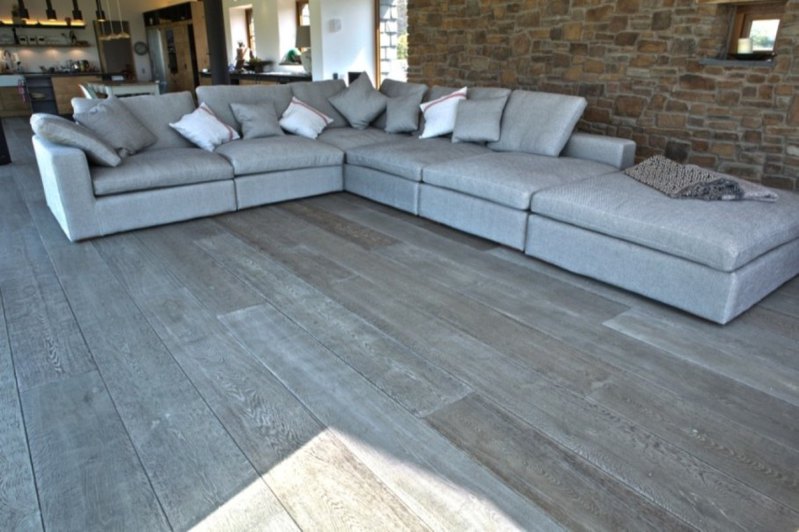 living room with fabulous gray hardwood floor idea feat stone wall interior design and elegant sectional leather sofa