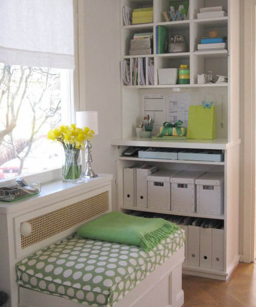 window seat with green pillows