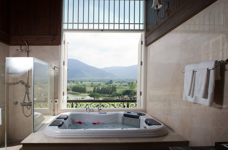 Bathroom with amazing view of the outdoors with design of polished porcelain tiles in a peach/cream shade