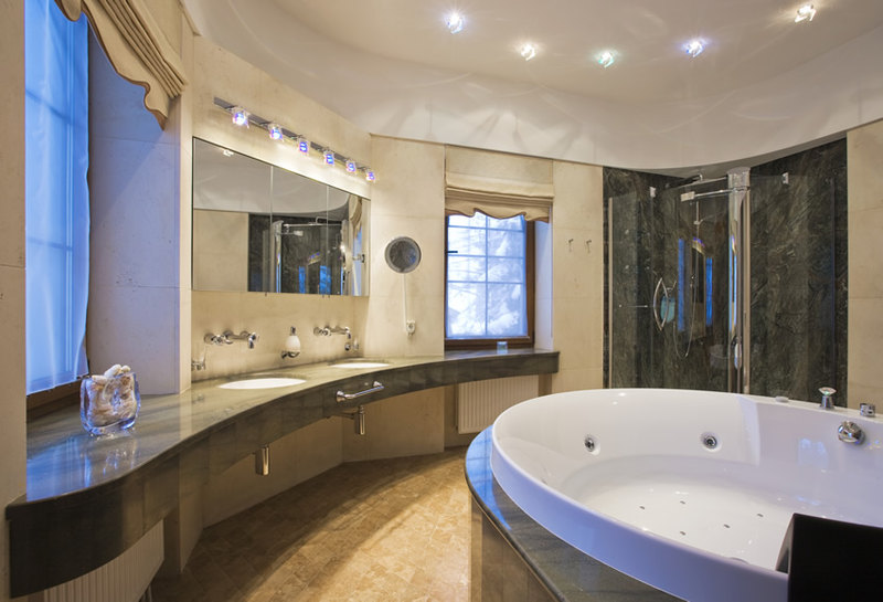 Bathroom with large jacuzzi bath and black design shower