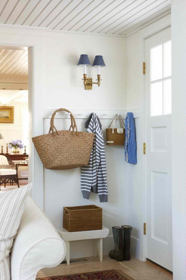 Small space in the hallway with simply wall hooks and small bench also rattan basket and lovel wall sconces decoration Easy Hallway Organization with Mudroom Furniture Ideas