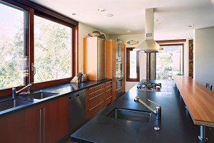 Galley-style kitchen with cooktop and prep sink