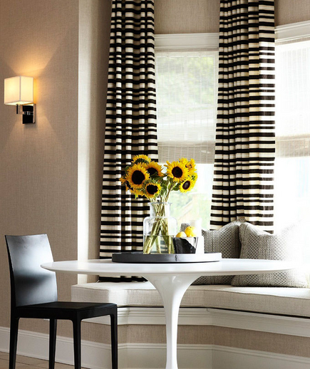 Small dining table, window seat and horizontal stripe curtains