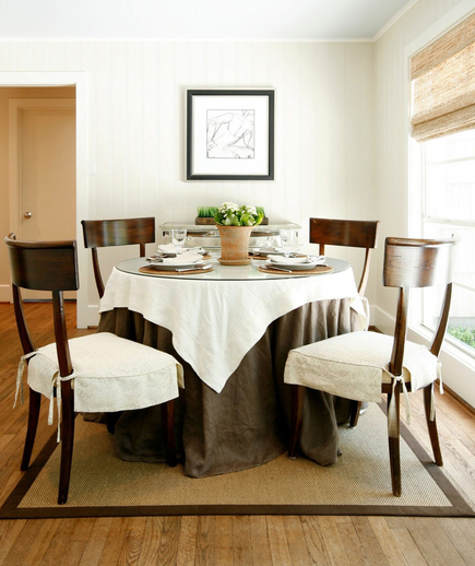 Full Skirted: Linen and glass covered dining room table Linen and glass covered dining room table