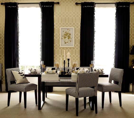 Zebra striped chairs and fringed curtains in a dining room