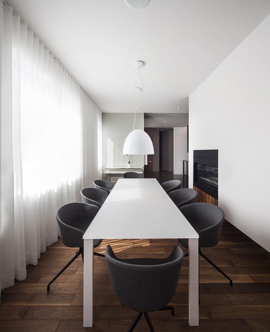 Minimalist Design Dining Room With Wooden Floor And White Table