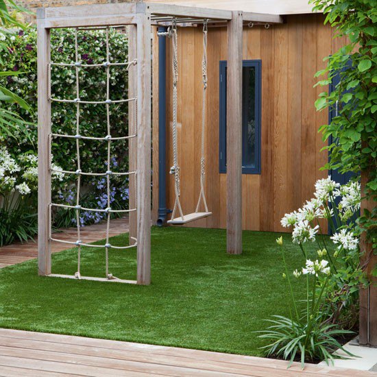 Cedar playhouse, swing and climbing frame with artificial grass