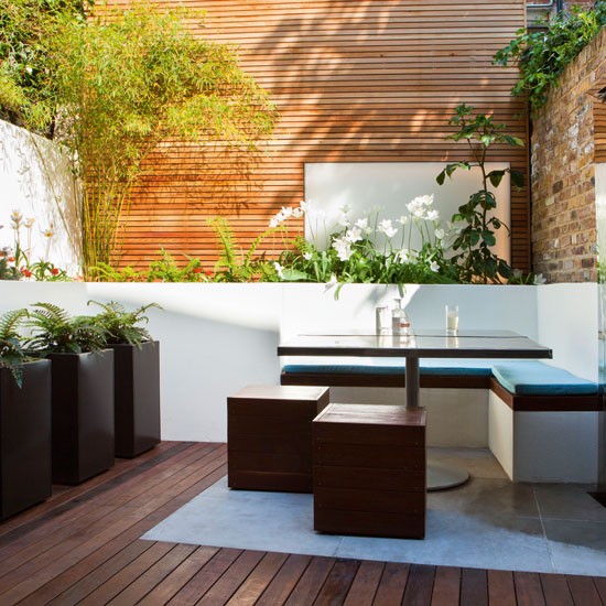 Decked garden with square table and black stools