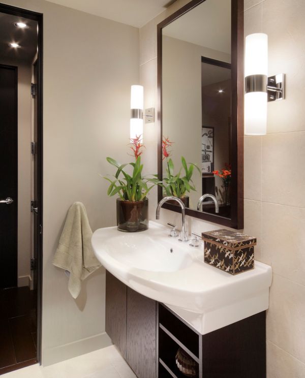 Sleek and lovely sconce lights next to the mirror in the bath