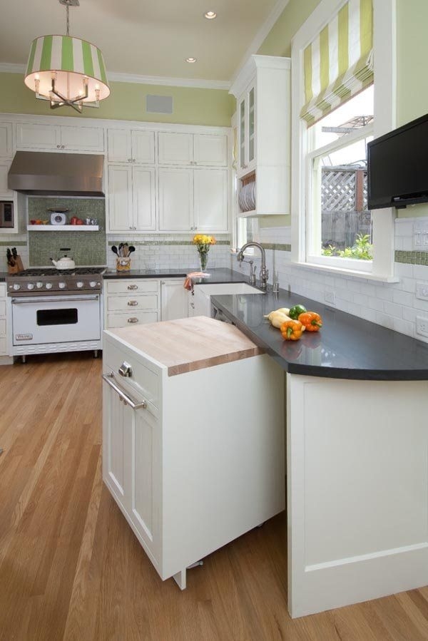 Instead of typical cabinets, build a pull-out cabinet for instant counter space.