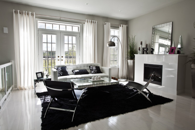 Grey hardwood floor concept: Living room with fireplace and chairs