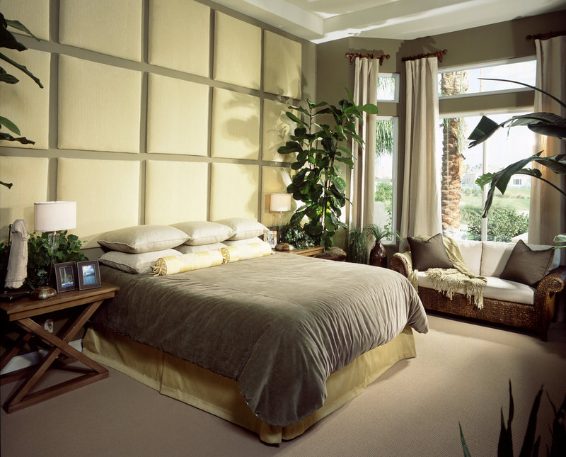 The padded wall panels are what stands out in this bedroom design which span the entire wall against which is the bed