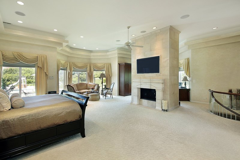 Large bright master bedroom that takes up the entire top floor of this luxury home