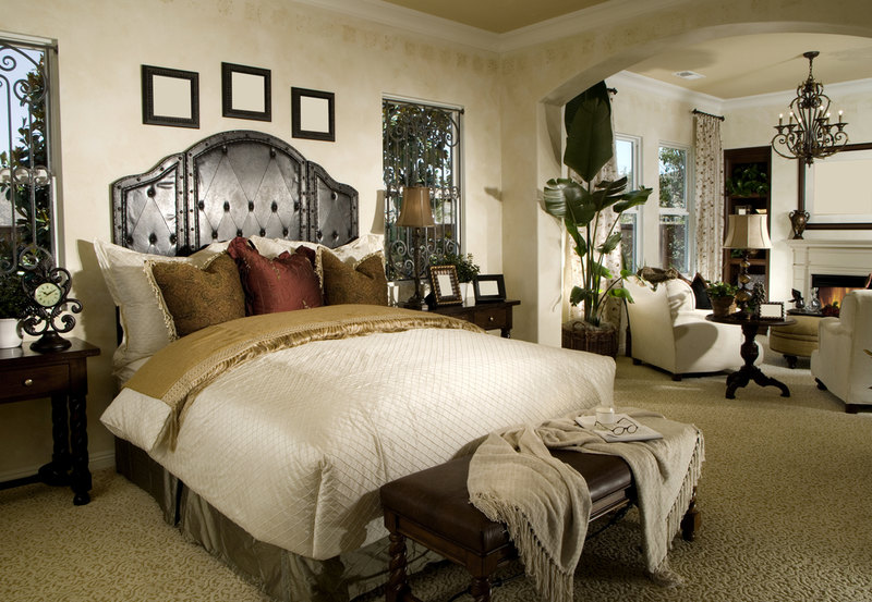 Large ornately designed master bedroom with separate living room.