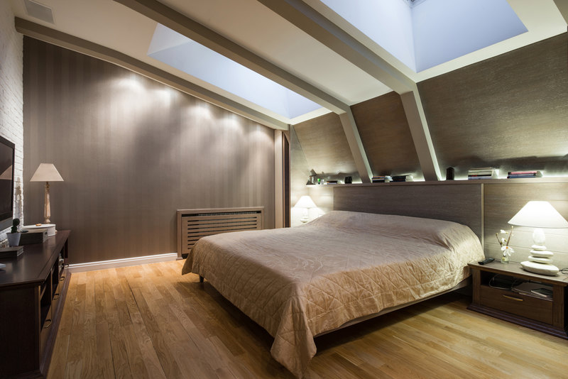Modern bedroom with two skylights on sloped ceiling