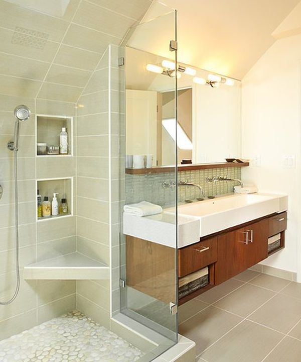 Classy floating sink cabinet set in a contemporary bathroom clad in glass