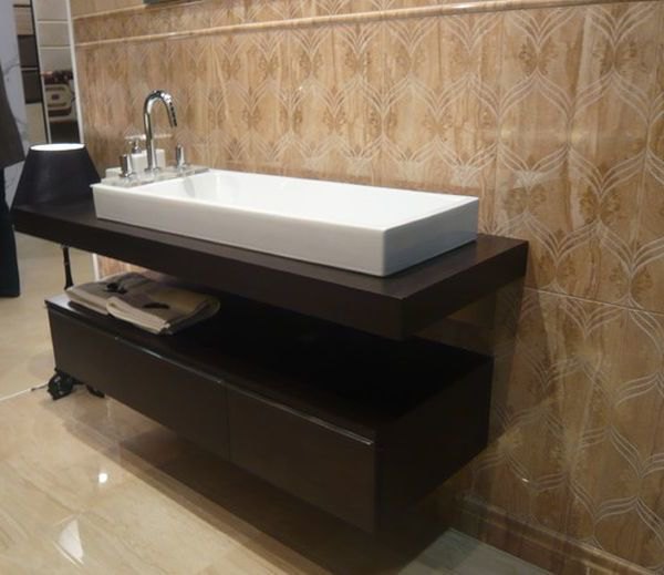 Marble floored bathroom with gorgeous floating sink and cabinet form