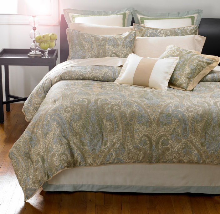Lovely paisley linens in creams, sages, and blues are complemented by a variety of trimmed accent pillows in coordinating colors.