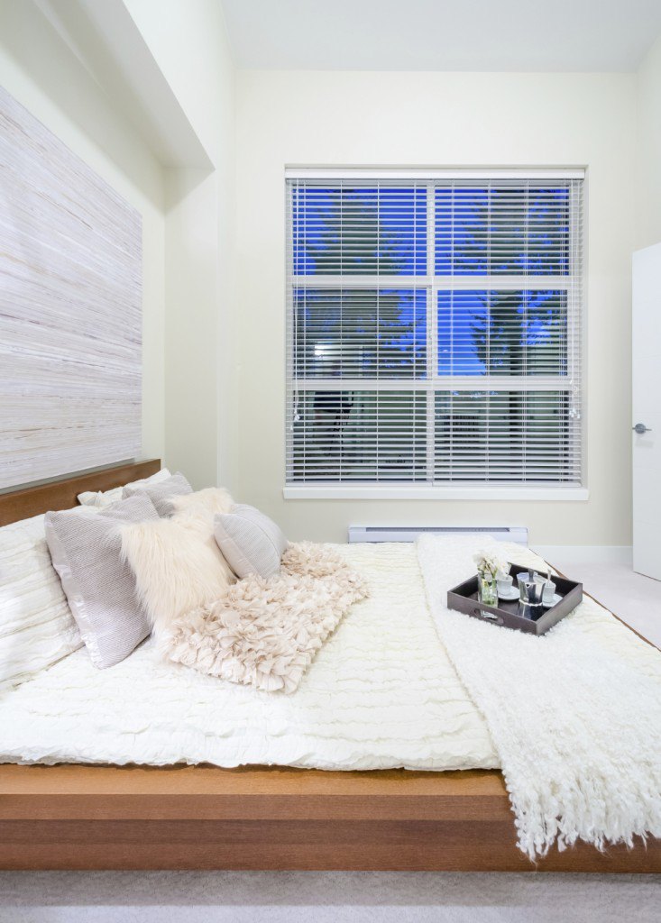 A soft, pleasing neutral palette is made more powerful through the use of soft and varied textures on the linens and numerous throw pillows atop this comfortable and plush bed. This otherwise minimalist bedroom comes to life with the inclusion of this outstanding arrangement of accent pillows.