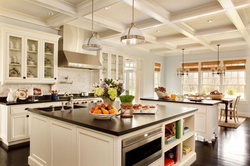 This impressive kitchen has a lot going on. The beautiful wood floors complement the granite countertops and bring depth to this airy room. Glass-fronted doors separate the white of the cabinets while the decor adds bright pops of colors. The powder blue walls keep the kitchen light and open while adding additional color to the room. Similarly, the recessed ceiling squares bring visual interest to even the top of the room. 