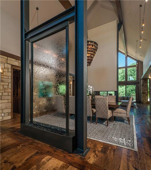 Large indoor fountain with clear waterfall surface 