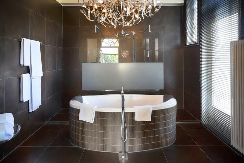 Modern bathroom with 60x60 rustic brown porcelain tiles for walls and floors and rustic brown mosaic tiles