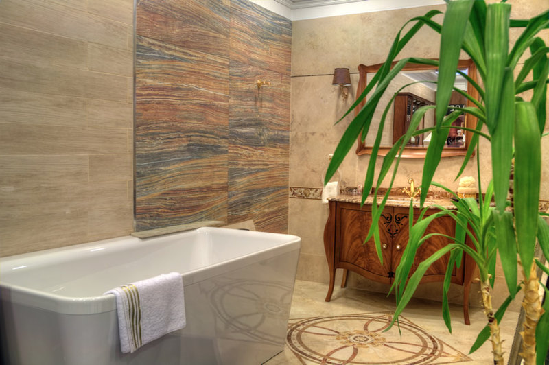 Small luxury bathroom with polished natural travertine walls and floors of polished granite with a unique design