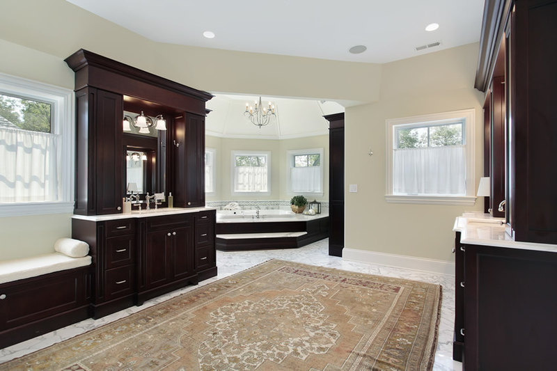 Bathroom uses dark Mahogany wood tones for vanity and wooden elements, with finishes of lighter colors