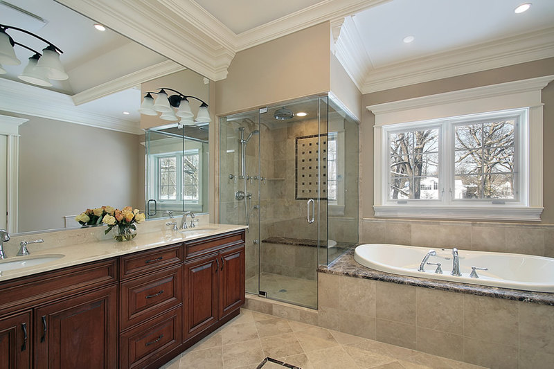 Elegant master bathroom with high quality polished natural stone tiles, combined with a nice warm beige paint 