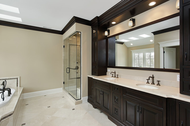 Master bathroom uses white stone finish ceramic tiles with accents of dark brown mosaic tiles Master bathroom uses white stone finish ceramic tiles with accents of dark brown mosaic tiles