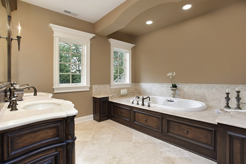 Bathroom with warm brown walls and moldings with porcelain tile flooring and white granite countertop Bathroom with warm brown walls and moldings with porcelain tile flooring and white granite countertop