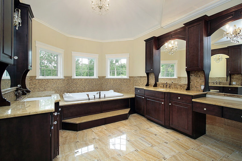 Spacious bathroom that has a beautiful contrast of dark and light colors