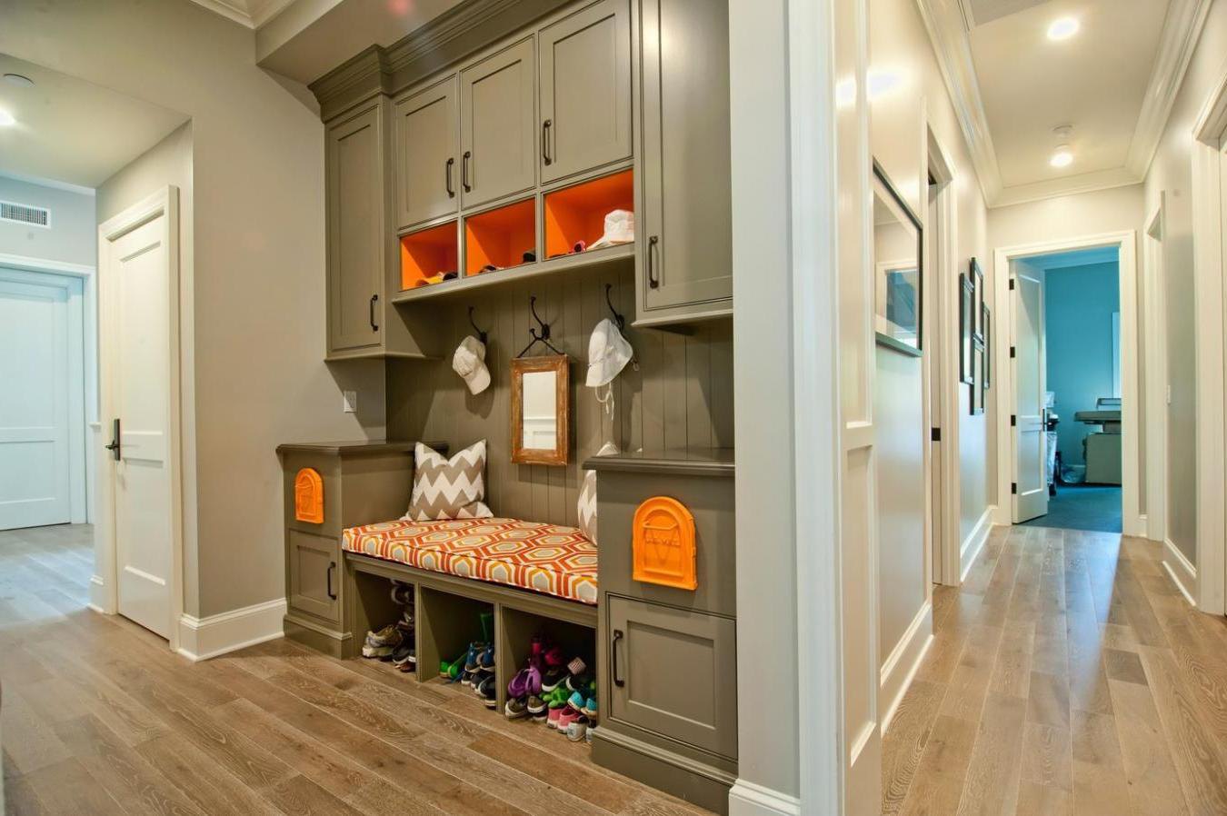 Bright hallway with gray cupboard and shoe storage bench also simply wall hooks