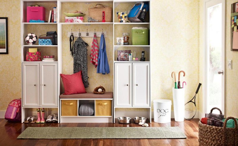 Wonderful hallway with nice wooden cupboard with shelves and cabinets also umbrella case and rug on laminate wooden floor