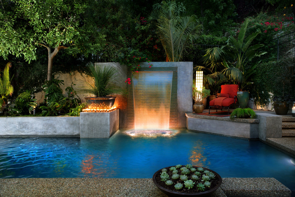 fantastic-waterfall-and-pool-idea-feat-red-outdoor-chair-furniture-plus-stunning-landscape-lighting-