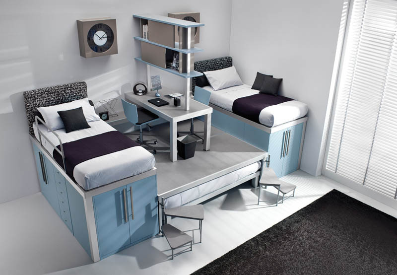 raised bunk beds with storage underneath and desk in the middle with a third bed underneath