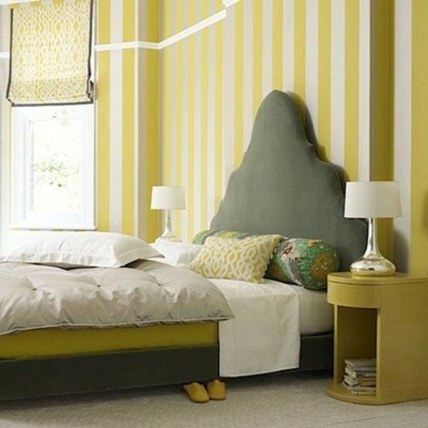 Wall behind bed headboard bed yellow stripes bedside lamp