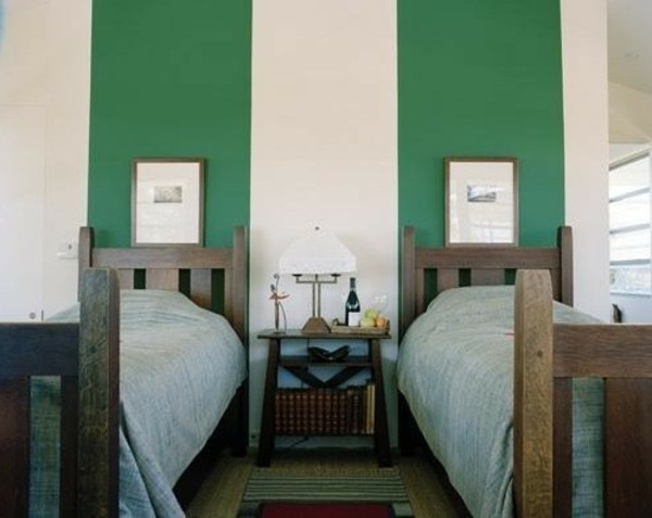 Wall behind the headboard bed green bedside table