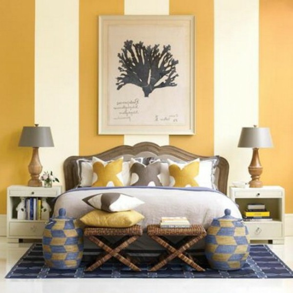 Stripes wall behind the headboard bed bedside table lamp yellow