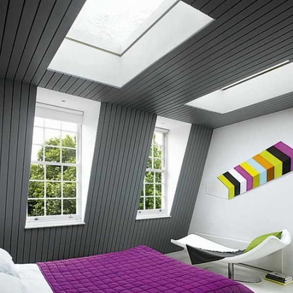 bedrooms in the attic gray wall covering pink bedspread skylights