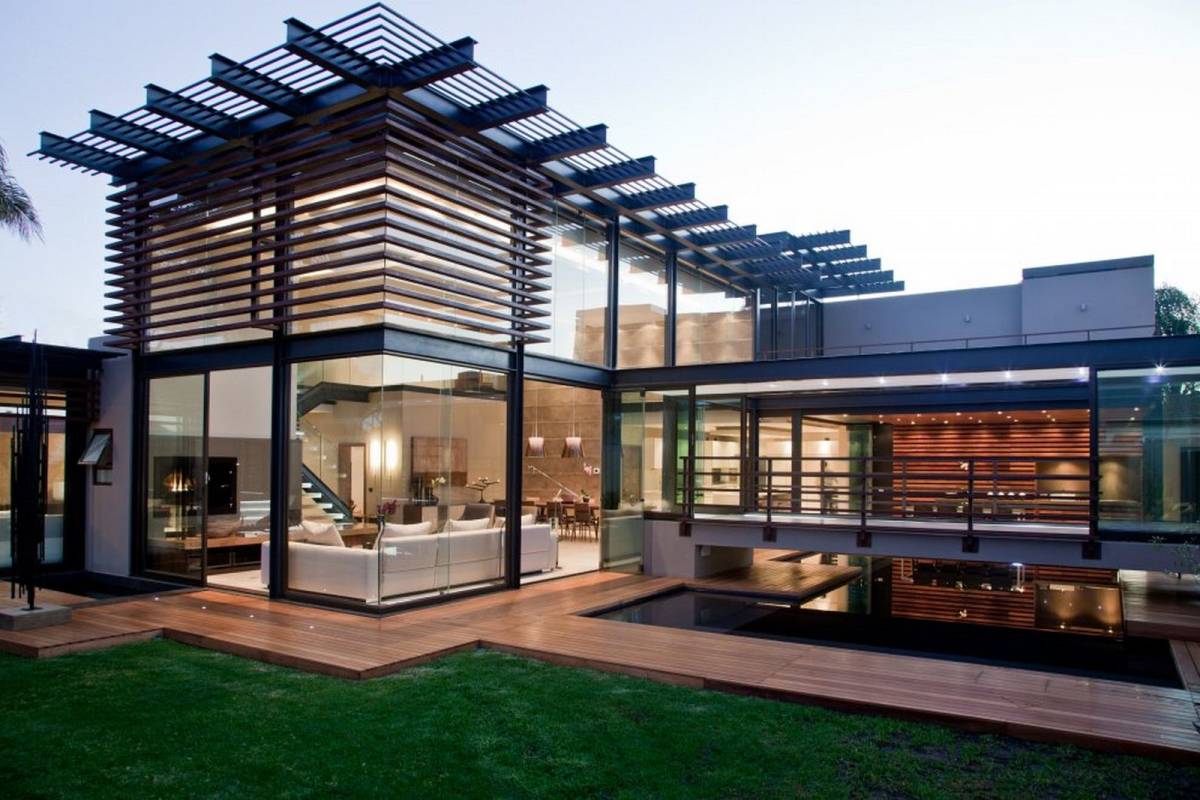 Contemporary home exterior design idea with glass wall and green grass