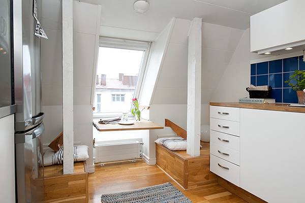 Inspirational design for attic room with window, table and kitchen