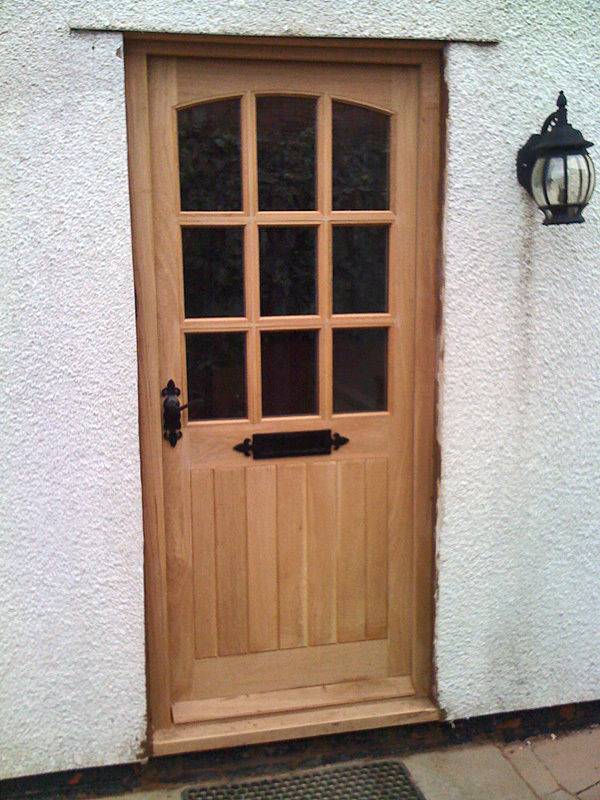 Simple solid front door with sidelight