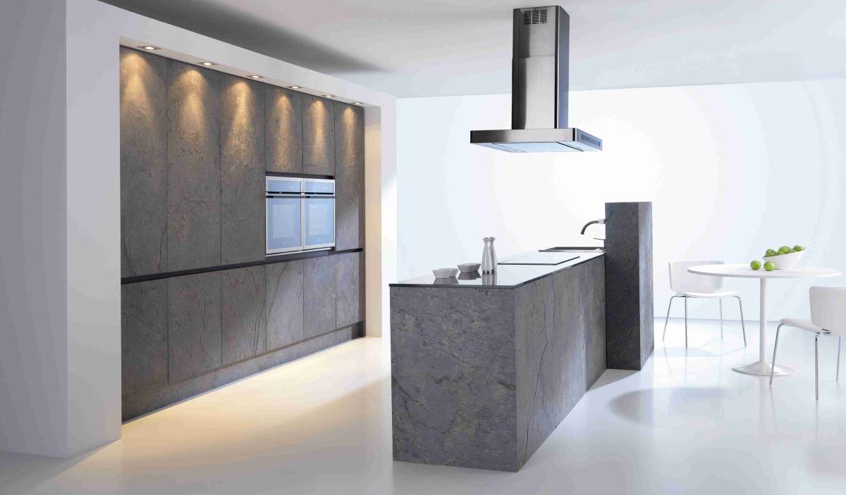 Unusual concrete cabinets and island in contemporary minimalist kitchen with excellent lighting