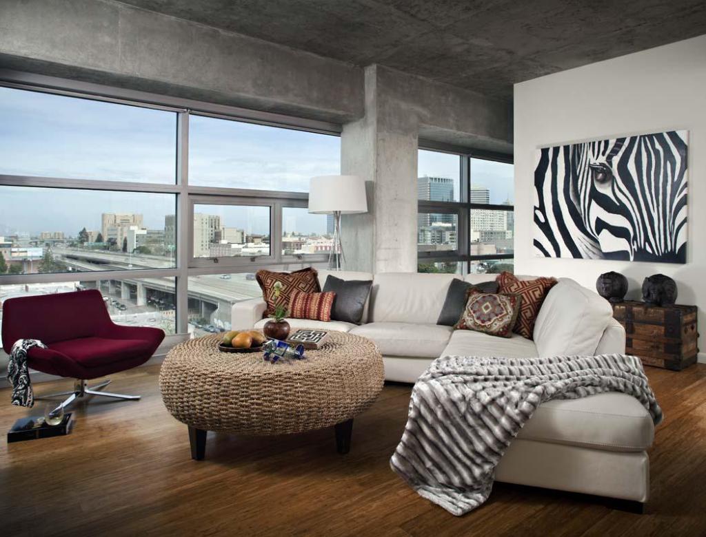 enchanting living room in loft with concrete ceiling as well round table plus white sofa and wide glass window view city