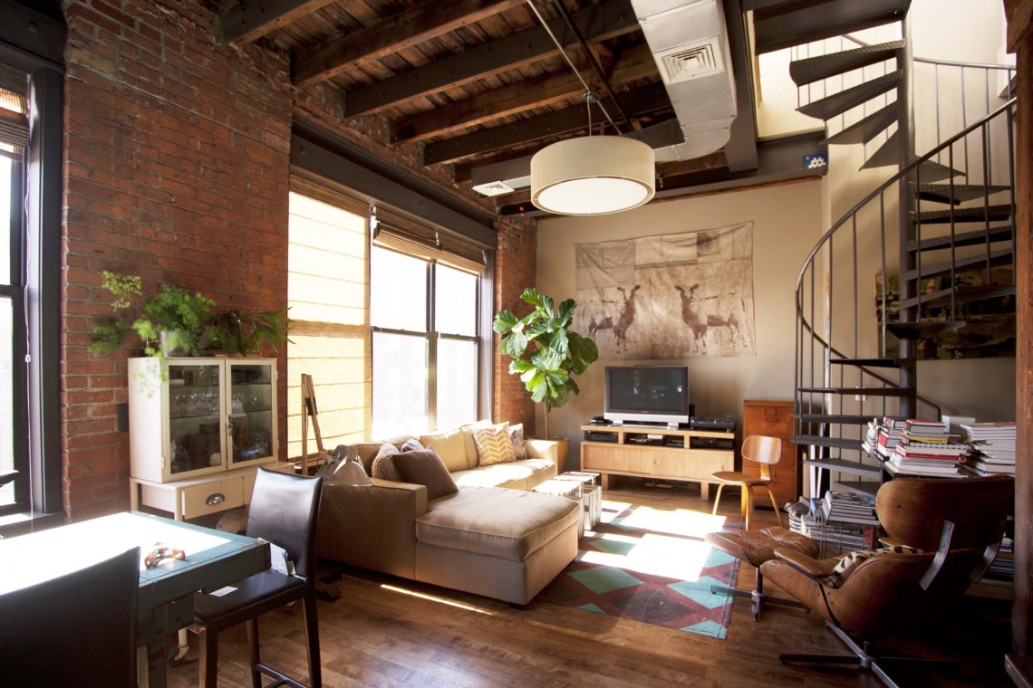 Industrial living room with stairs to bedroom with cool furniture