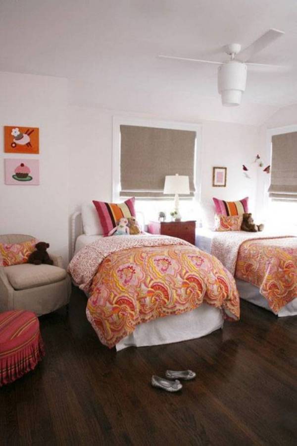 Small bedroom for two beds for twins with colorfull comforter and brown blinds