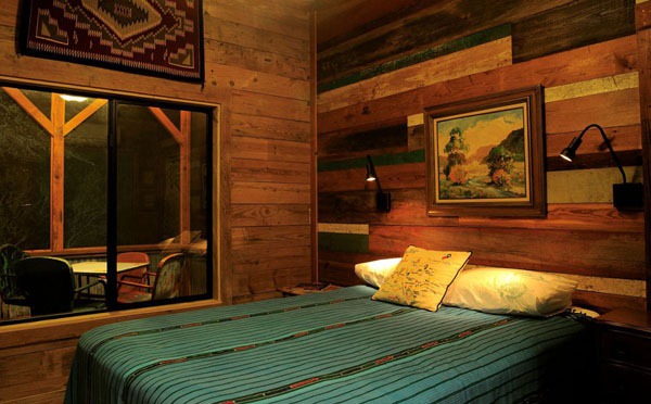 bedroom mirror wall blue blanket landscape painting wood walls beige green