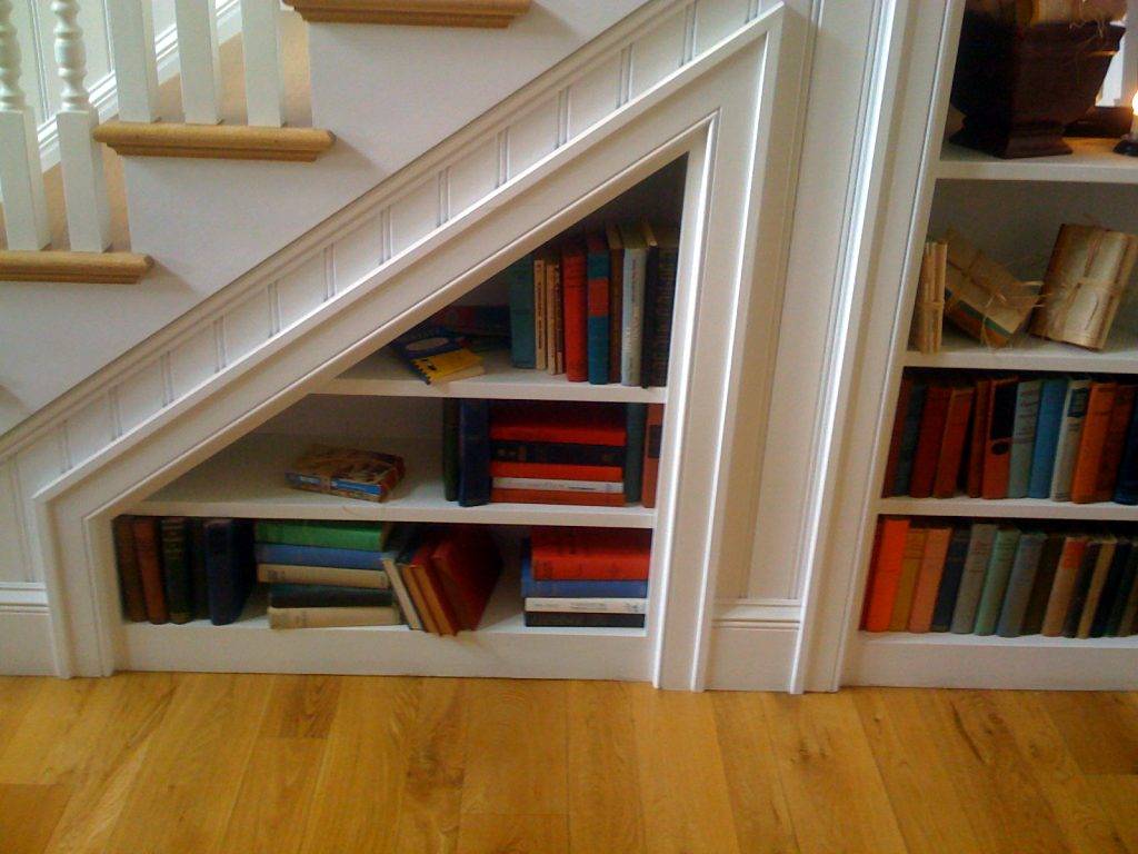 Bookshelves in the staircase as a great idea of space-saving techniques