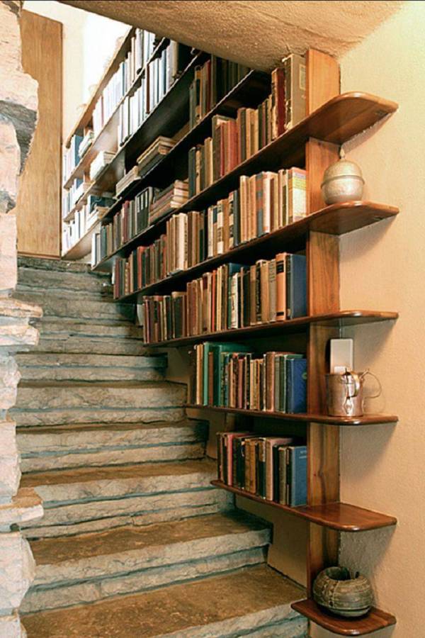 Bookshelves in the staircase as a great idea of space-saving techniques